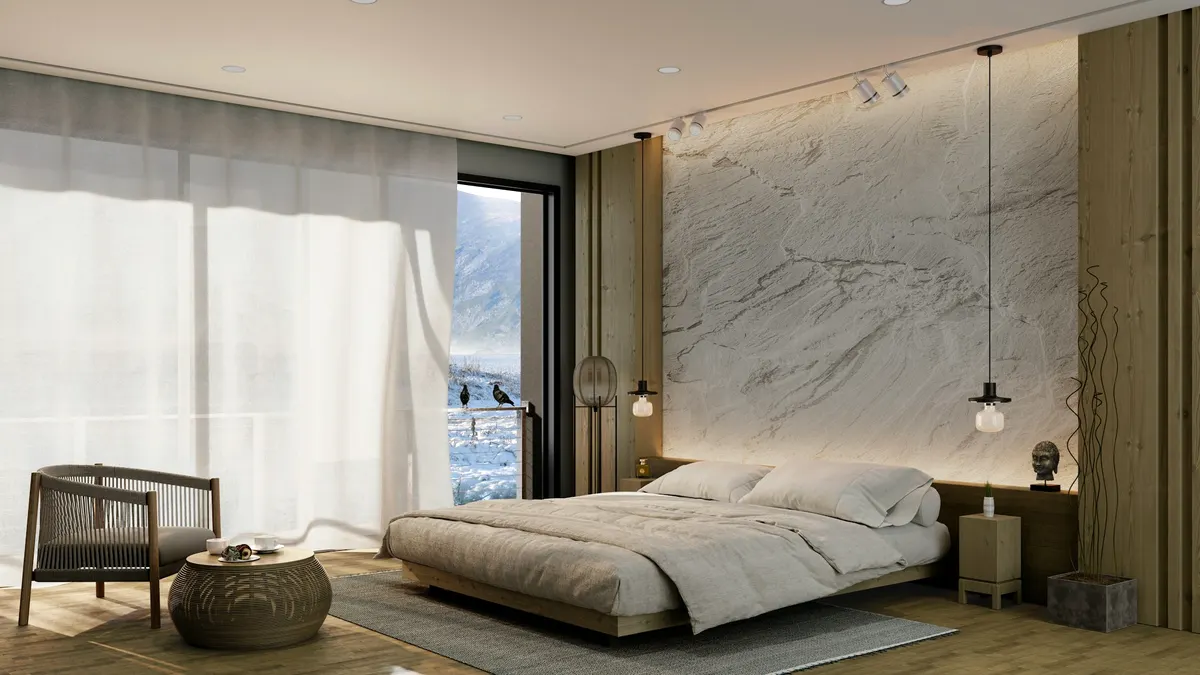 Suite mit Natursteinwand und Pendelleuchten über dem Bett